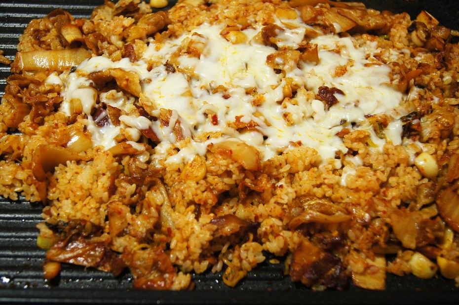 Kimchi fried rice with melted cheese on a Korean BBQ grill plate