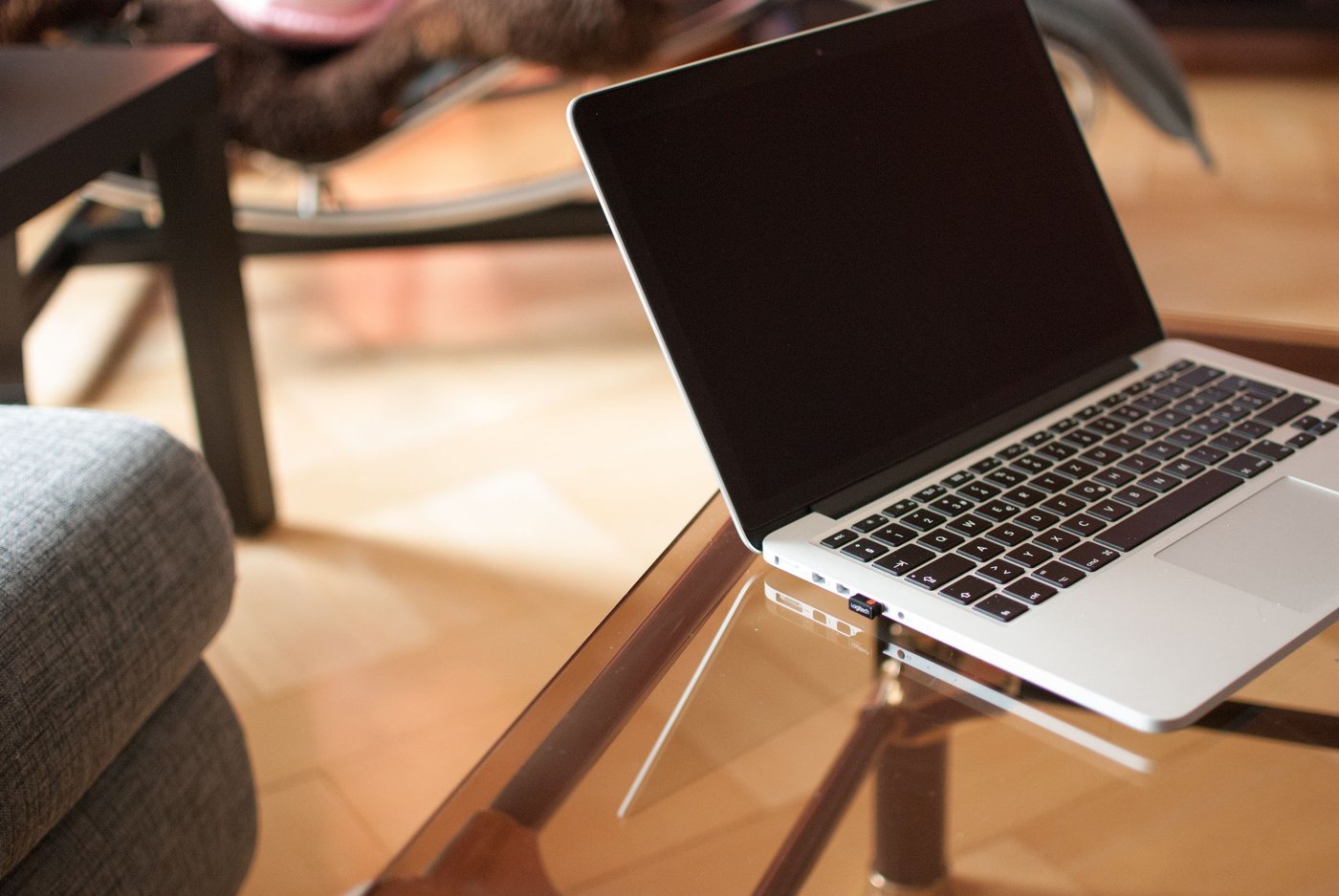 Open laptop left on a glass table, as is common in Korean cafés