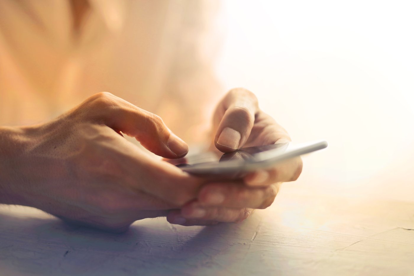 Close-up of hands typing Korean internet slang on smartphone