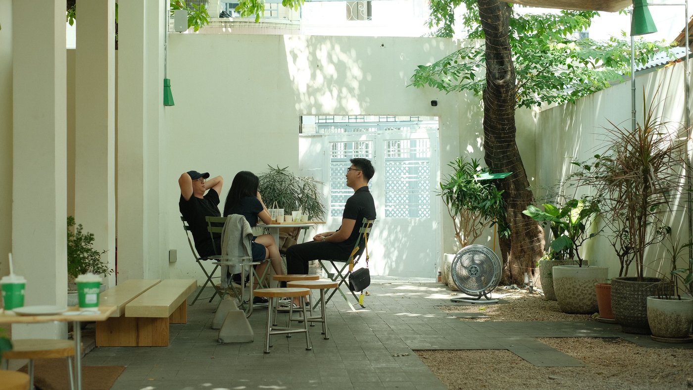 People interacting and reading the room in a Korean cafe terrace