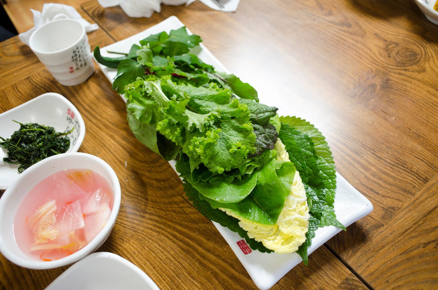 A platter of Korean ssam greens with lettuce, perilla leaves and napa cabbage